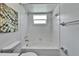 Bathroom showing the white tiled shower/tub and toilet at 113 Patrick Henry Rd, Bartow, FL 33830