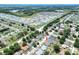 Aerial view of a residential neighborhood with mature trees, showcasing the home's location at 1140 Stratton Ave, Groveland, FL 34736