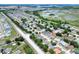 Expansive aerial view of a neighborhood with mature trees and a nearby lake offering scenic beauty at 1140 Stratton Ave, Groveland, FL 34736