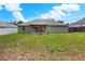 Large backyard with a patio, and a mix of grass and natural areas, perfect for outdoor enjoyment at 1140 Stratton Ave, Groveland, FL 34736