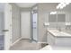 Bathroom featuring walk-in shower, white cabinets, quartz countertops, and neutral paint colors at 1140 Stratton Ave, Groveland, FL 34736