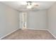 Bedroom featuring neutral walls, carpet floors, ceiling fan and view to the bathroom at 1140 Stratton Ave, Groveland, FL 34736
