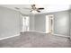 Bright bedroom with neutral gray color palette and plush carpeting at 1140 Stratton Ave, Groveland, FL 34736