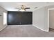 Spacious bedroom with neutral colors, ceiling fan, and a modern accent wall at 1140 Stratton Ave, Groveland, FL 34736