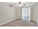 Bedroom featuring neutral walls, carpet floors, ceiling fan and view to other rooms at 1140 Stratton Ave, Groveland, FL 34736