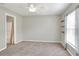 Bedroom features include carpet floors, a ceiling fan, curtains, and shelving at 1140 Stratton Ave, Groveland, FL 34736