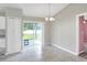 Bright dining area with tiled floor and sliding glass doors to backyard at 1140 Stratton Ave, Groveland, FL 34736