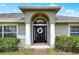 Front door featuring a wreath, arched window above the door, and two sidelights at 1140 Stratton Ave, Groveland, FL 34736