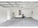 Spacious garage featuring a water heater, neutral paint, and ample room for vehicles and storage at 1140 Stratton Ave, Groveland, FL 34736