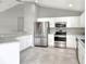 Modern kitchen with white cabinets, stainless steel appliances, and speckled countertops at 1140 Stratton Ave, Groveland, FL 34736