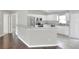 Modern kitchen with white cabinets, stainless steel appliances, and granite countertops at 1140 Stratton Ave, Groveland, FL 34736