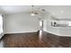 Living room with vaulted ceilings, hardwood floors, and views to modern kitchen at 1140 Stratton Ave, Groveland, FL 34736