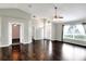 Bright living room featuring hardwood floors, high ceilings, a ceiling fan, and a large window at 1140 Stratton Ave, Groveland, FL 34736