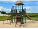 Community playground featuring a slide and climbing area in a sandy space at 1140 Stratton Ave, Groveland, FL 34736