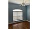 Cozy bedroom with a ceiling fan, blue walls, and a window with natural light at 1167 Motorcoach Dr, Polk City, FL 33868