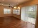 Bright dining room featuring wood floors, stylish chandelier, and sliding glass doors to the outside at 1167 Motorcoach Dr, Polk City, FL 33868