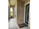 Welcoming front entrance features a decorated glass front door and tiled porch at 1167 Motorcoach Dr, Polk City, FL 33868