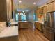 Open kitchen with granite countertops, stainless steel appliances, and a breakfast bar overlooking the living space at 1167 Motorcoach Dr, Polk City, FL 33868