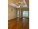 Bright living room with wood floors, large windows, and a decorative front door at 1167 Motorcoach Dr, Polk City, FL 33868