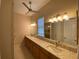 Main bathroom features double sinks with granite countertops and ample cabinet space at 1167 Motorcoach Dr, Polk City, FL 33868