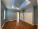 Spacious main bedroom with wood floors, a tray ceiling with lighting, and large closets at 1167 Motorcoach Dr, Polk City, FL 33868