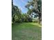 Expansive backyard with mature trees offering shade, ideal for creating a serene outdoor retreat at 1215 E Edgewood Dr, Lakeland, FL 33803