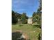 Landscaped backyard with a decorative shed, offering a tranquil outdoor space at 1215 E Edgewood Dr, Lakeland, FL 33803