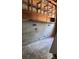 Unfinished basement area showcasing block wall construction and exposed ceiling with wood shelving at 1215 E Edgewood Dr, Lakeland, FL 33803