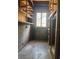 Unfinished basement with shelving and window, offering potential for customized storage or living space at 1215 E Edgewood Dr, Lakeland, FL 33803
