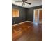 Bedroom features hardwood floors, a ceiling fan, and glass doors to the outside, offering a private retreat at 1215 E Edgewood Dr, Lakeland, FL 33803