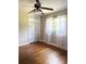 Bedroom boasts hardwood floors, closet, ceiling fan, and natural light, creating a cozy and inviting space at 1215 E Edgewood Dr, Lakeland, FL 33803