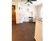Spacious kitchen features white cabinets, stainless steel dishwasher, and ceiling fan for a functional workspace at 1215 E Edgewood Dr, Lakeland, FL 33803