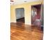 Spacious living room with gleaming hardwood floors, arched doorway and seamless flow into other areas of the home at 1215 E Edgewood Dr, Lakeland, FL 33803