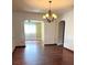 Bright living room with hardwood floors, a chandelier and arched doorways offers charm and character at 1215 E Edgewood Dr, Lakeland, FL 33803