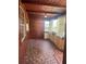Bright sunroom showcasing unique tile flooring, wood paneling, and large windows, creating a warm and inviting atmosphere at 1215 E Edgewood Dr, Lakeland, FL 33803
