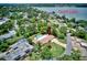 Aerial view of a home with a pool, landscaping and trees, located in a desirable residential neighborhood at 1235 Lake Point Dr, Lakeland, FL 33813