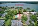 Aerial view of home with a pool and patio near Scott Lake in a beautiful residential area at 1235 Lake Point Dr, Lakeland, FL 33813