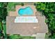 Aerial view of a beautiful backyard pool with a brick patio area next to an attractive home at 1235 Lake Point Dr, Lakeland, FL 33813