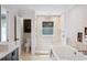 Elegant bathroom featuring a soaking tub, walk-in shower, and dark wood vanity at 1235 Lake Point Dr, Lakeland, FL 33813