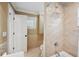 Bright bathroom with a tile shower and tub, neutral walls, and a white door and window at 1235 Lake Point Dr, Lakeland, FL 33813