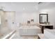 Luxurious bathroom boasting a soaking tub, glass shower, and modern vanity with elegant finishes and fixtures at 1235 Lake Point Dr, Lakeland, FL 33813
