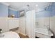 Classic bathroom with blue walls, tiled shower, and vintage style fixtures and decor at 1235 Lake Point Dr, Lakeland, FL 33813
