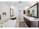Spacious bathroom with dual sinks, a soaking tub, a separate shower, and modern finishes and fixtures at 1235 Lake Point Dr, Lakeland, FL 33813