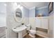 Charming bathroom featuring a pedestal sink, mosaic floors, and soft blue accents at 1235 Lake Point Dr, Lakeland, FL 33813