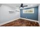 Bright bedroom boasts hardwood floors, modern paint, recessed lights, and a ceiling fan at 1235 Lake Point Dr, Lakeland, FL 33813
