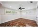 Airy bedroom with hardwood floors, wainscotting and bright windows with natural light at 1235 Lake Point Dr, Lakeland, FL 33813