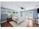 Bedroom featuring blue walls, hardwood floors, a ceiling fan, and french doors leading to an outdoor area at 1235 Lake Point Dr, Lakeland, FL 33813