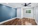 Stylish bedroom boasts hardwood floors, a ceiling fan, and plenty of natural light at 1235 Lake Point Dr, Lakeland, FL 33813