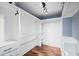 Walk-in closet featuring custom white shelving, drawers, and hardwood flooring with ample storage space at 1235 Lake Point Dr, Lakeland, FL 33813