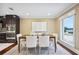 Modern dining room featuring large windows and seamlessly connected to a kitchen with stainless steel appliances at 1235 Lake Point Dr, Lakeland, FL 33813